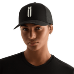 Woman Wearing Black Be U Trucker Hat Front Angle.
