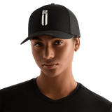 Woman Wearing Black Be U Trucker Hat Front Angle.