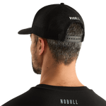 Man Wearing Black Be U Trucker Hat Back Angle.